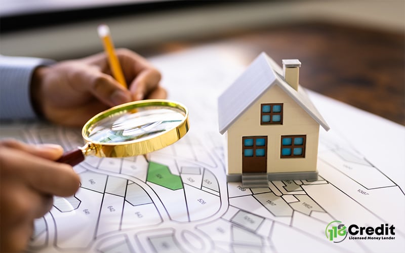 Private housing model on map with magnifying glass and pencil