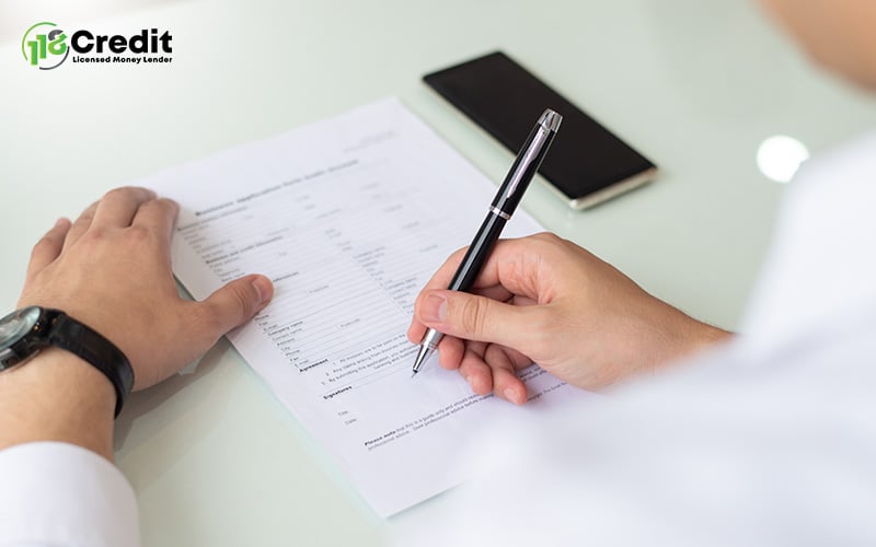 Man signing a contract for a home loan.
