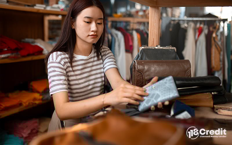 Woman choosing a new wallet to boost money flow.