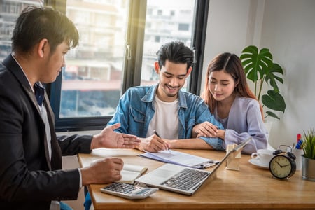 Couple Signing Personal Loan Documents with a Moneylender in Singapore