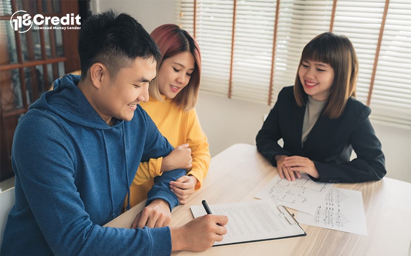 Singapore couple signs personal loan agreement with licensed moneylender.