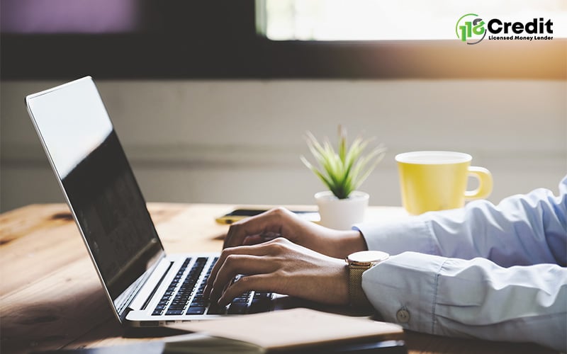 Working on a laptop for a side hustle.