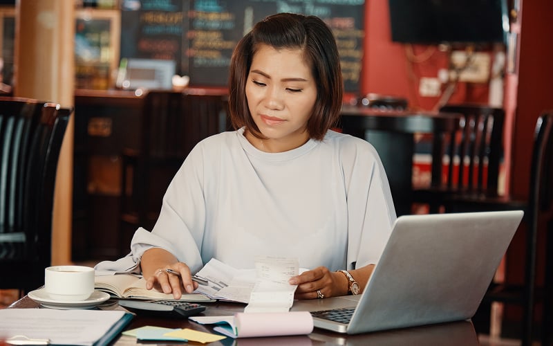 Woman reviewing financial receipts before her next loan application.