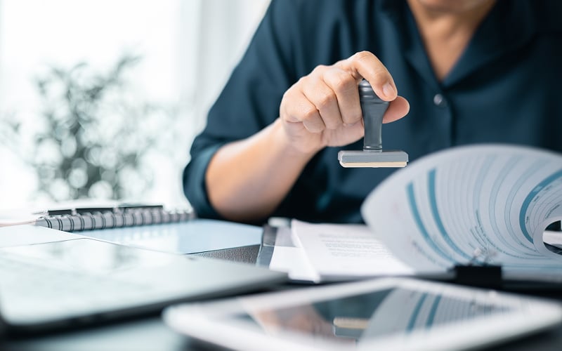 Banking-officer-stamping-documents-for-personal-loan-approval-Singapore.
