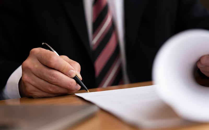Lawyer signing legal expense loan documents.